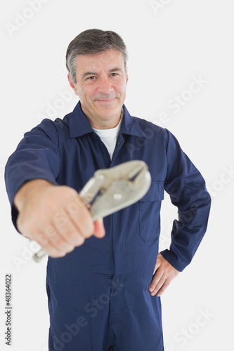 Photo: Portrait of mechanic holding vise grip Portrait of mechanic holding vise grip