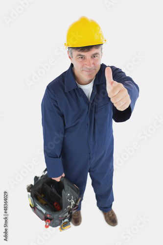 Photo: Technician with tool bag gesturing thumbs up Technician with tool bag gesturing thumbs up