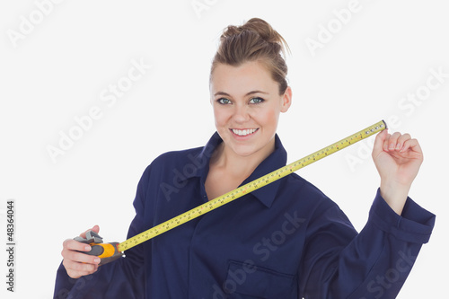 Photo: Female technician holding measuring tape Female technician holding measuring tape