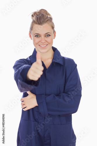 Photo: Female mecanic showing thumbs up sign Female mecanic showing thumbs up sign
