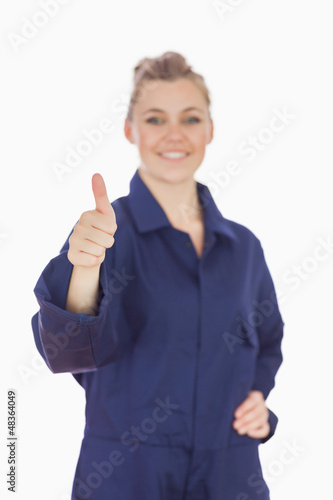 Photo: Female mechanic showing thumbs up sign Female mechanic showing thumbs up sign