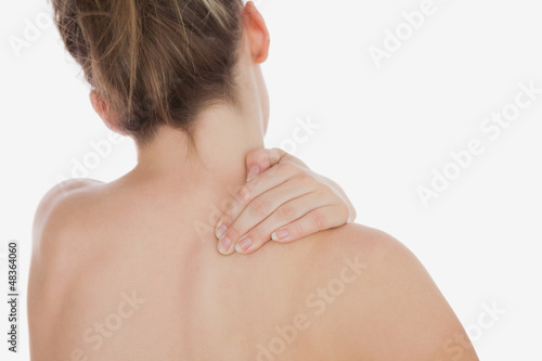 Photo: Topless woman massaging back Topless woman massaging back