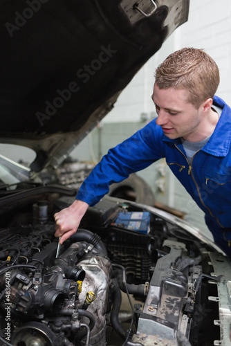 Photo: Car mechanic working on engine Car mechanic working on engine