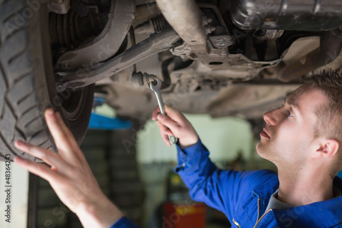 Photo: Auto mechanic working under car Auto mechanic working under car