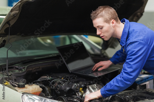 Photo: Car mechanic with laptop Car mechanic with laptop