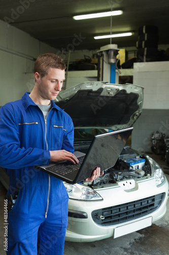 Photo: Mechanic using laptop Mechanic using laptop