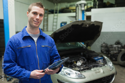 Photo: Auto mechanic holding tablet computer Auto mechanic holding tablet computer