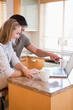 Couple using laptop at home