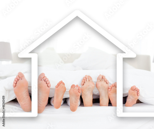 Photo: Feet family in the duvet with house illustration Feet family in the duvet with house illustration