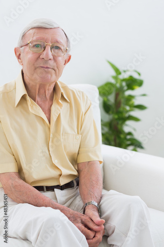 Photo: Elderly man sitting on the sofa Elderly man sitting on the sofa
