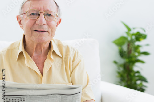 Photo: Cheerful elderly man reading the news Cheerful elderly man reading the news