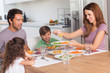 Mother serving vegetables to daughter at dinner