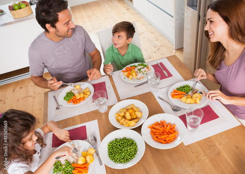 Photo: Family smiling around a healthy meal Family smiling around a healthy meal