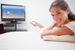 Smiling woman watching television
