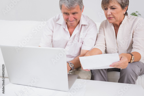 Photo: Old couple not understanding the accounts and using laptop Old couple not understanding the accounts and using laptop