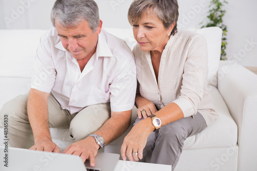 Photo: Old couple using a laptop Old couple using a laptop