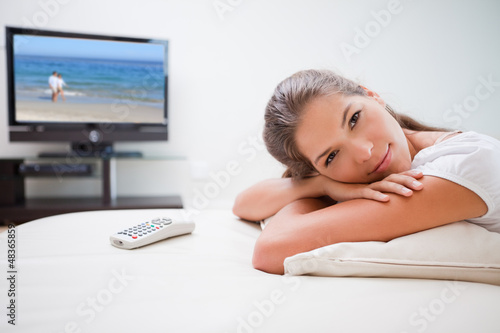 Photo: Woman relaxing in front of the television Woman relaxing in front of the television