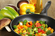 Sliced fresh vegetables in pan with spices and ingredients