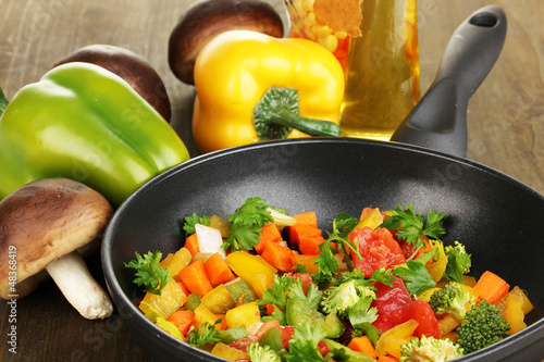 Photo: Sliced fresh vegetables in pan with spices and ingredients Sliced fresh vegetables in pan with spices and ingredients