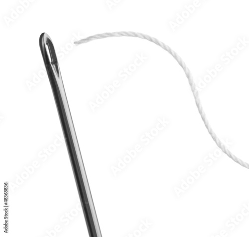 Photo: needle and thread on a white background needle and thread on a white background