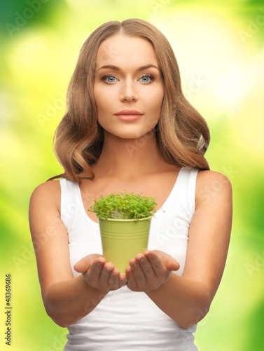 Photo: woman with green grass in pot woman with green grass in pot