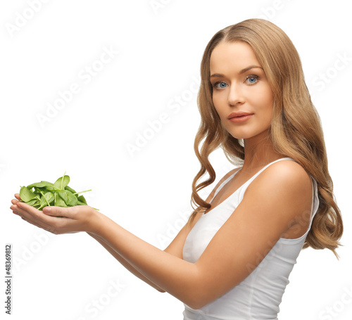 Photo: woman with spinach leaves on palms woman with spinach leaves on palms