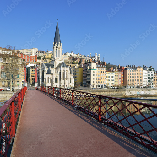 Photo: red footbridge and church red footbridge and church