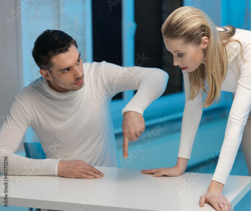 Photo: man and woman working with something man and woman working with something