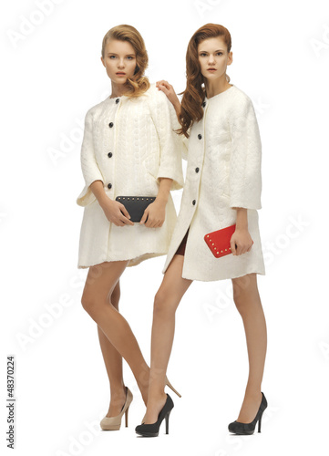 Photo: two teenage girls in white coats with clutches two teenage girls in white coats with clutches