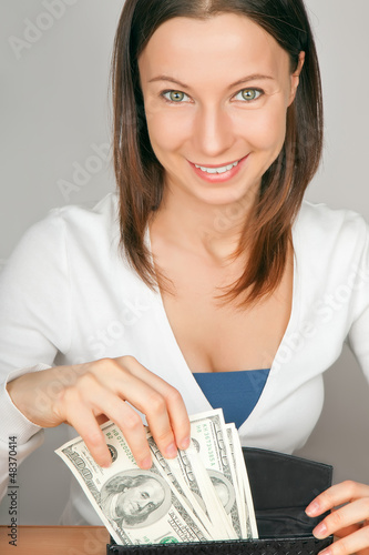Photo: young woman with cash young woman with cash