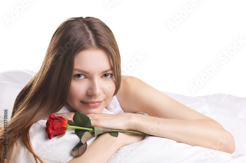 Photo: young woman with rose in a beg young woman with rose in a beg