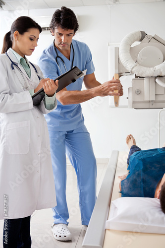 Photo: Radiologists With Patient In X-ray Room Radiologists With Patient In X-ray Room