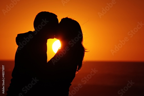 Photo: loving couple beach sunset loving couple beach sunset