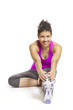 Muscular young woman stretching in sports outfit