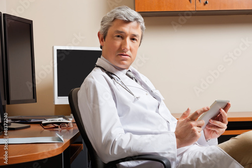Photo: Doctor Holding Digital Tablet Doctor Holding Digital Tablet