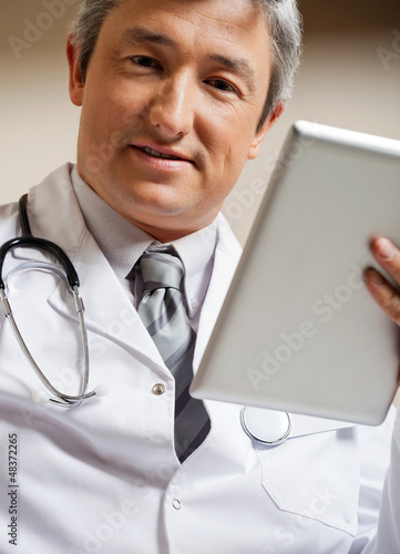 Photo: Doctor Holding Digital Tablet Doctor Holding Digital Tablet