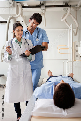 Photo: Medical Professionals Communicating With Patient Medical Professionals Communicating With Patient
