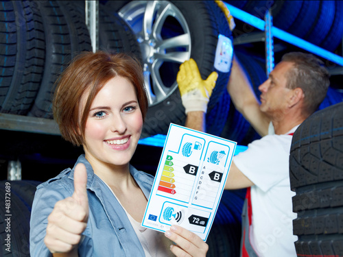 Photo: Happy female customer shows thumb up for EU tire labeling Happy female customer shows thumb up for EU tire labeling