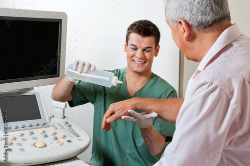Photo: Technician Putting Gel On Patient's Hand Technician Putting Gel On Patient's Hand