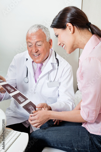 Photo: Radiologist Showing Ultrasound Print To Patient Radiologist Showing Ultrasound Print To Patient