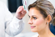 Optometry concept - pretty young woman having her eyes examined