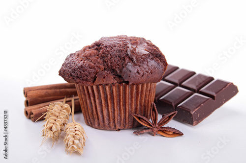 Photo: chocolate muffin and ingredient on white chocolate muffin and ingredient on white