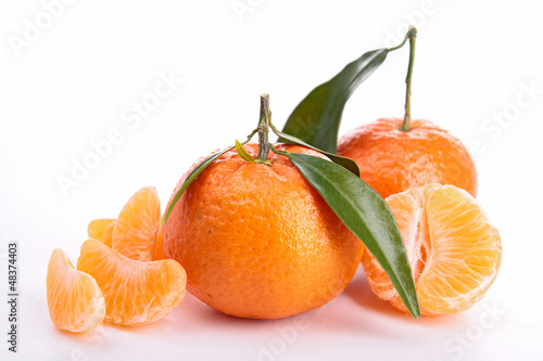 Photo: isolated clementine and leaf on white isolated clementine and leaf on white