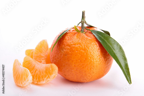 Photo: isolated clementine and leaf on white isolated clementine and leaf on white