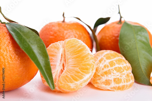 Photo: isolated clementine and leaf on white isolated clementine and leaf on white
