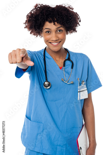 Photo: Smiling lady doctor pointing you out Smiling lady doctor pointing you out