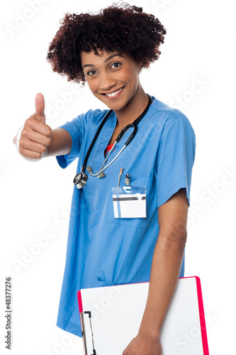 Photo: Happy lady doctor showing thumbs up sign Happy lady doctor showing thumbs up sign