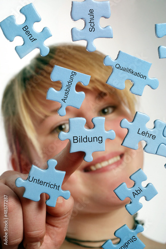 Photo: Junge Frau legt Puzzle-Teile zusammen zum Thema Ausbildung Junge Frau legt Puzzle-Teile zusammen zum Thema Ausbildung