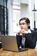 Confident businesswoman and laptop