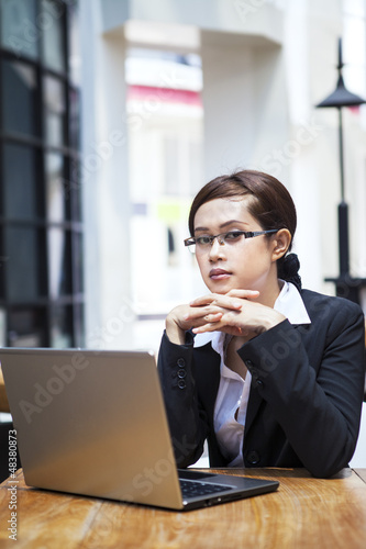 Photo: Confident businesswoman and laptop Confident businesswoman and laptop